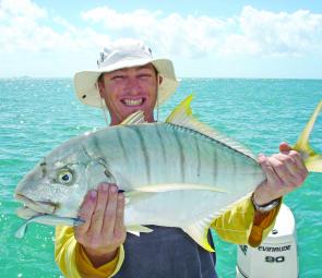 James Burn displaying a golden trevally caught on a soft plastic at Gould Island.